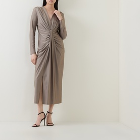 Model wearing Joseph Ribkoff Platinum Grey midi dress with ruched front, V-neckline and long sleeves, styled with black strappy heels.