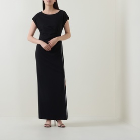 Model wearing Joseph Ribkoff Rhinestone Side-Slit Gown Dress in black, cap sleeves, boat neck, maxi length with rhinestone-trimmed front split.
