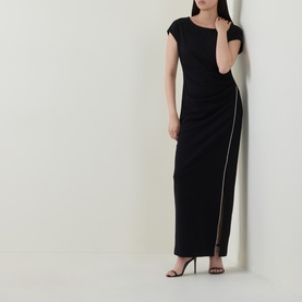 Model wearing Joseph Ribkoff Rhinestone Side-Slit Gown Dress in black, cap sleeves, boat neck, rhinestone-trimmed front split, styled with black heels