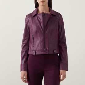 Model wearing Joseph Ribkoff Studded Faux Leather Jacket in Elderberry, featuring stud trim, zip front and notch lapel, styled with matching trousers