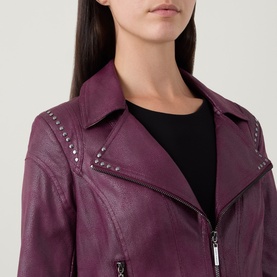 Model wearing Joseph Ribkoff Studded Faux Leather Jacket in Elderberry, featuring silver stud detailing on notch lapel collar and zip fastening.