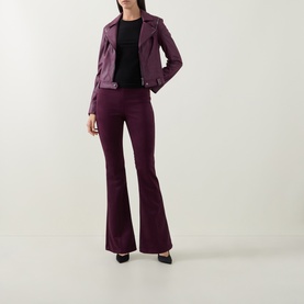 Model wearing Joseph Ribkoff Studded Faux Leather Jacket in Elderberry with matching flared trousers and black heels.