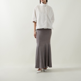 Model wearing Joseph Ribkoff Cream Chevron Quilted Faux Fur Jacket with funnel neck, styled with grey maxi skirt and white heels.