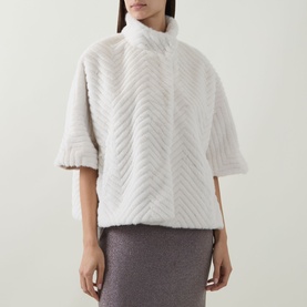 Model wearing Joseph Ribkoff Chevron Quilted Faux Fur Jacket in cream, with funnel neck and half-length sleeves, styled with a grey skirt