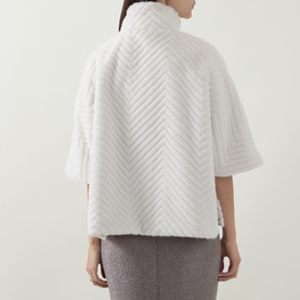 Model wearing Joseph Ribkoff Chevron Quilted Faux Fur Jacket in cream, showing back view with chevron pattern, funnel neck and half-length sleeves