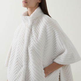 Model wearing Joseph Ribkoff Chevron Quilted Faux Fur Jacket in cream, featuring funnel neck, chevron pattern, and half-length sleeves