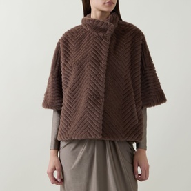 Model wearing Joseph Ribkoff Chevron Quilted Faux Fur Jacket in Mink, featuring funnel neck and half-length sleeves, styled with grey top and skirt.