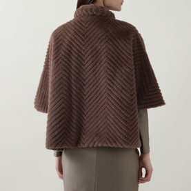 Model wearing Joseph Ribkoff Chevron Quilted Faux Fur Jacket in Mink, back view showing chevron pattern, funnel neck and half-length sleeves