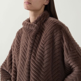 Model wearing Joseph Ribkoff Chevron Quilted Faux Fur Jacket in Mink, featuring funnel neck and chevron-textured faux fur finish