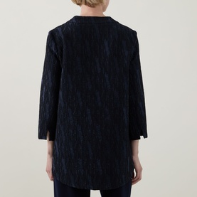 Model wearing Joseph Ribkoff Navy Jacket, rear view, textured crinkle fabric, three-quarter sleeves, longline silhouette with side slits.
