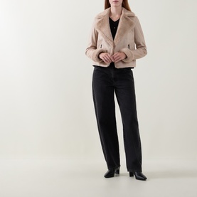 Model wearing Joseph Ribkoff Soft Taupe jacket with faux fur collar, styled with black trousers and heeled boots.