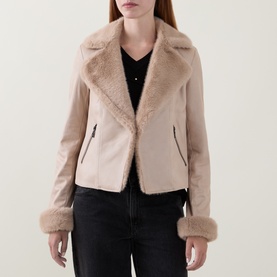 Model wearing Joseph Ribkoff Jacket in Soft Taupe with faux shearling lapels and cuffs, styled with black jeans.