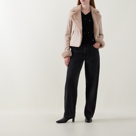 Model wearing Joseph Ribkoff Soft Taupe faux fur jacket with black knit top and wide-leg black jeans, styled with black heeled boots.