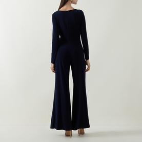 Model wearing Joseph Ribkoff Jumpsuit in Midnight Blue, back view, long sleeves, wide-leg silhouette, fitted waist.