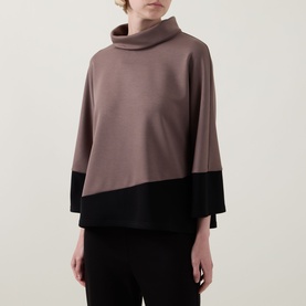 Model wearing Joseph Ribkoff Top in Mink and Black with colour-block design, cowl neck, and wide 3/4-length sleeves, paired with black trousers.