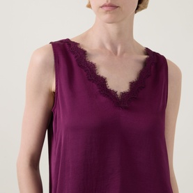 Model wearing Joseph Ribkoff Berry Burst sleeveless top with V-neckline and delicate lace trim detail.
