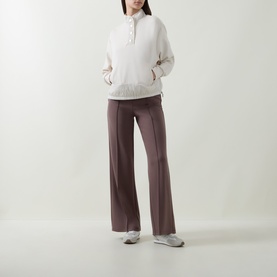 Model wearing Joseph Ribkoff Textured-Trim Sweatshirt in Birch with stand collar and button placket, styled with mauve wide-leg trousers and grey
