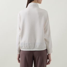 Model wearing Joseph Ribkoff Textured-Trim Sweatshirt in Birch, showing back view with stand collar, contrasting trim and elasticated hem.
