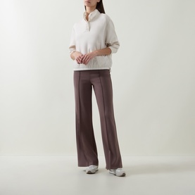 Model wearing Joseph Ribkoff Textured-Trim Sweatshirt in Birch with stand collar and contrast trim, styled with wide-leg trousers and silver trainers.