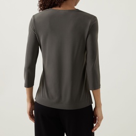 Model wearing Joseph Ribkoff Contrast Neckline Top in Avocado/Black, three-quarter sleeves, straight hem, back view, styled with black trousers.