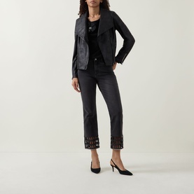 Model wearing Joseph Ribkoff black top, styled with black leather jacket, black cropped trousers with cut-out hem detail, and black slingback heels.