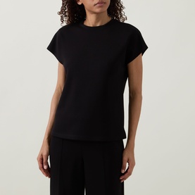 Model wearing Joseph Ribkoff black sleeveless top with crew neck and cap sleeves, styled with black wide-leg trousers.