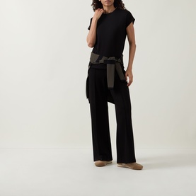 Model wearing Joseph Ribkoff black short-sleeve top with wide-leg black trousers and a khaki tied jacket at the waist.