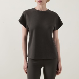 Model wearing Joseph Ribkoff Top in Avocado, short cap sleeves, crew neck, paired with matching slim trousers