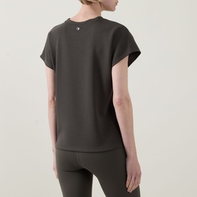 Model wearing Joseph Ribkoff Top in Avocado, short cap sleeves, relaxed back view, styled with matching leggings.