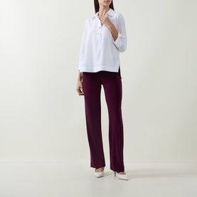 Model wearing Joseph Ribkoff vanilla top with collar and 3/4 sleeves, styled with burgundy wide-leg trousers and white heels.