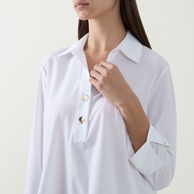 Model wearing Joseph Ribkoff vanilla polo-collar top with gold-tone buttons, long sleeves, in stretch fabric