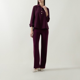 Model wearing Joseph Ribkoff elderberry top with gold button detail, styled with matching wide-leg trousers and nude heels.