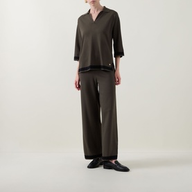 Model wearing Joseph Ribkoff Top in Avocado/Black with V-neck and lace trim, styled with matching wide-leg trousers and black loafers.