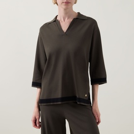 Model wearing Joseph Ribkoff Top in Avocado/Black with V-neckline, elbow sleeves, and contrast black trim, styled with matching wide-leg trousers.