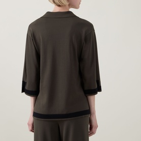 Model wearing Joseph Ribkoff Top in Avocado/Black, rear view, with black contrast trim on cuffs and hem, styled with matching trousers.