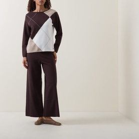 Model wearing Joseph Ribkoff Argyle Knitted Sweater in Mocha/Multi with wide-leg trousers and flat shoes.