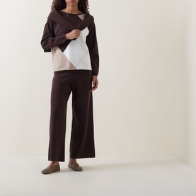 Model wearing Joseph Ribkoff Argyle Knitted Sweater in Mocha/Multi with wide-leg dark trousers and taupe flat shoes.