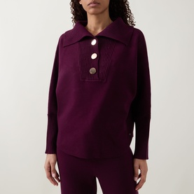 Model wearing Joseph Ribkoff Rib Knit Button Sweater in Elderberry with extended collar, half-button fastening and ribbed trims, styled with matching