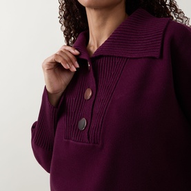 Model wearing Joseph Ribkoff Rib Knit Button Sweater in Elderberry with extended collar, ribbed trims, and half-button fastening detail.