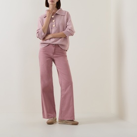 Model wearing Joseph Ribkoff Soft Blush Melange top with button placket and collar, styled with matching wide-leg trousers and flat shoes.