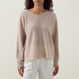 Model wearing Joseph Ribkoff cashmere top in Oatmeal Melange, V-neck with scattered embellishments, styled with white trousers