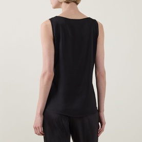Model wearing Joseph Ribkoff black sleeveless top, back view, with wide scoop neckline, paired with black wide-leg trousers