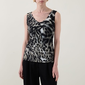 Model wearing Joseph Ribkoff grey/multi leopard print sleeveless top with V-neck, styled with black wide-leg trousers.
