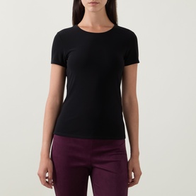 Model wearing Joseph Ribkoff Solid Fitted T-Shirt in black, crew neck, short sleeves, styled with burgundy trousers.