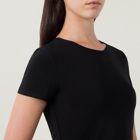 Model wearing Joseph Ribkoff Solid Fitted T-Shirt in black, crew neck, short sleeves, smooth finish with tonal stitching detail.