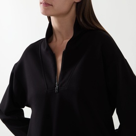 Model wearing Joseph Ribkoff Sporty Half-Zip Sweatshirt in black with shawl collar, half-zip fastening, and scuba fabric finish