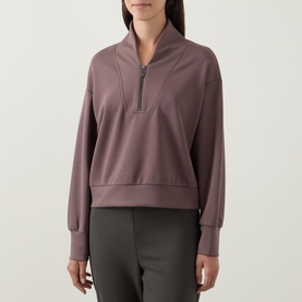 Model wearing Joseph Ribkoff Sporty Half-Zip Sweatshirt in Mink with shawl neck, half-zip placket, dropped shoulders and ribbed trims
