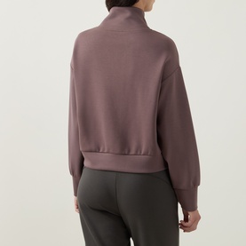 Model wearing Joseph Ribkoff Sporty Half-Zip Sweatshirt in Mink, rear view, showing dropped shoulders and ribbed trims, styled with dark khaki