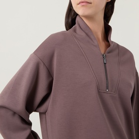 Model wearing Joseph Ribkoff Sporty Half-Zip Sweatshirt in Mink, featuring half-zip placket, shawl neckline and dropped shoulders