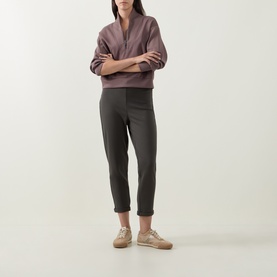 Model wearing Joseph Ribkoff Sporty Half-Zip Sweatshirt in Mink with shawl neckline, styled with dark grey tapered trousers and beige trainers.